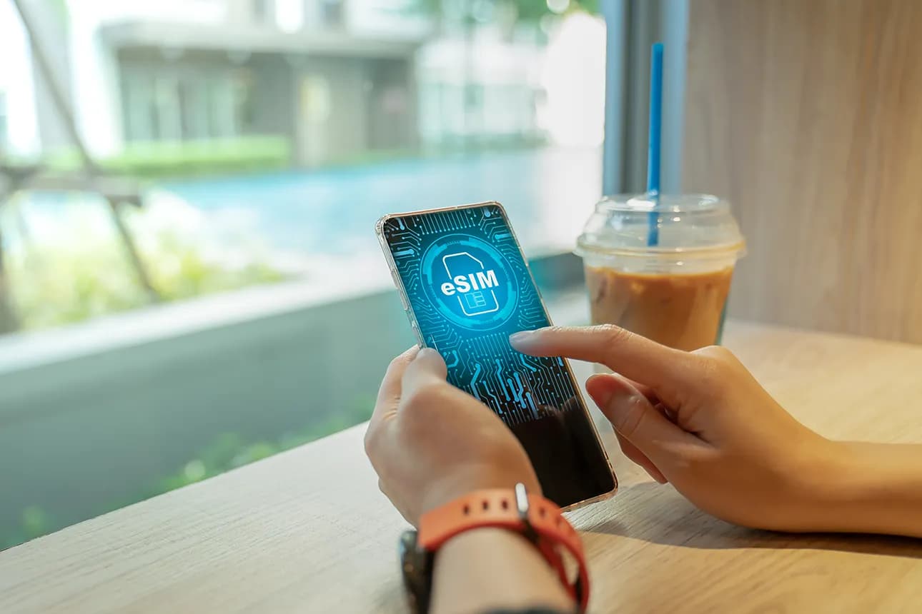 Woman using a phone with eSIM technology. Mobile device with a chip on a circuit board art - eSIM (Embedded SIM).
