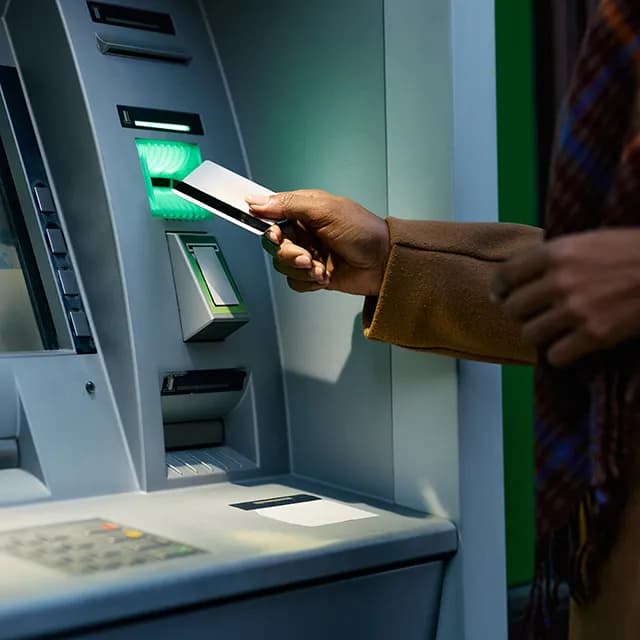 Person inserting card into ATM