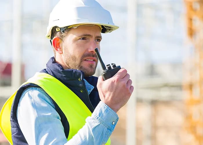 Construction worker using comms device