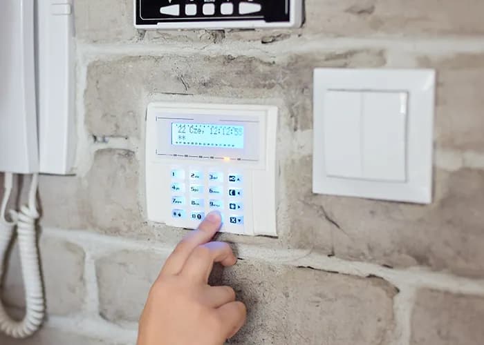 image of boy pushing a button on the alarm keypad