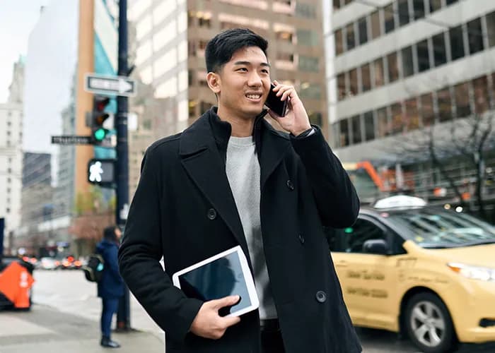 Young man using smartphone in city centre