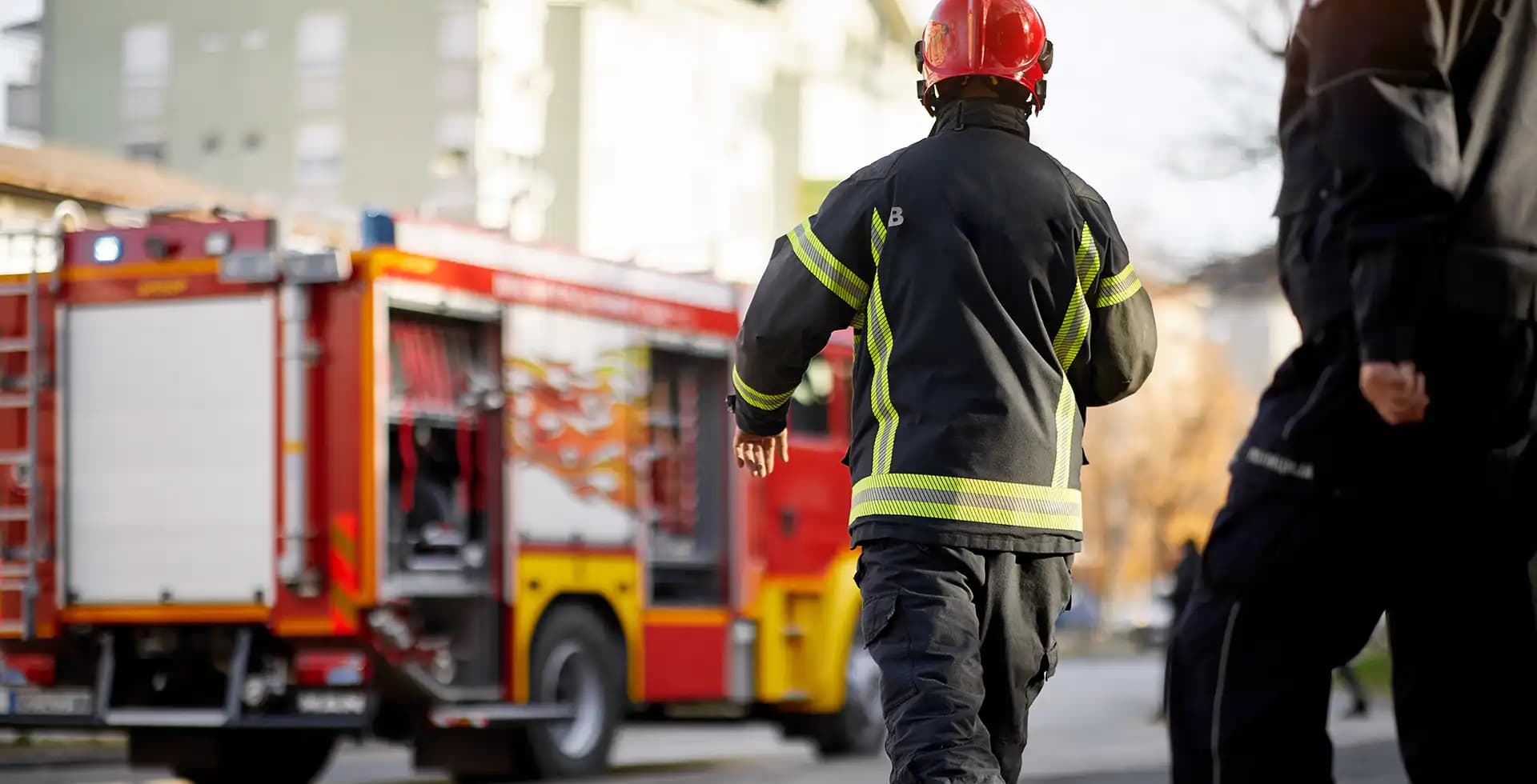 Firefighte next to fire engine